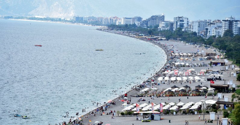 An aerial view of the people enjoying warm September weather at the famous Konyaaltı beach in Antalya, southern Türkiye, Sept. 21, 2024. (DHA Photo)