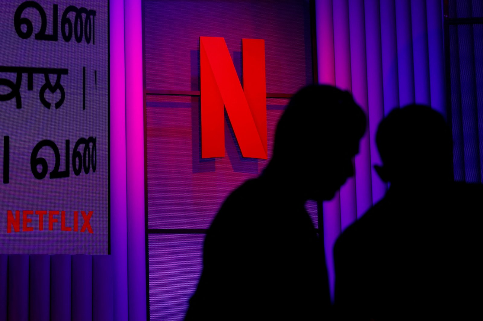 People stand next to the logos of a Netflix during at an event in Mumbai, India, Feb. 29, 2024. (Reuters Photo)