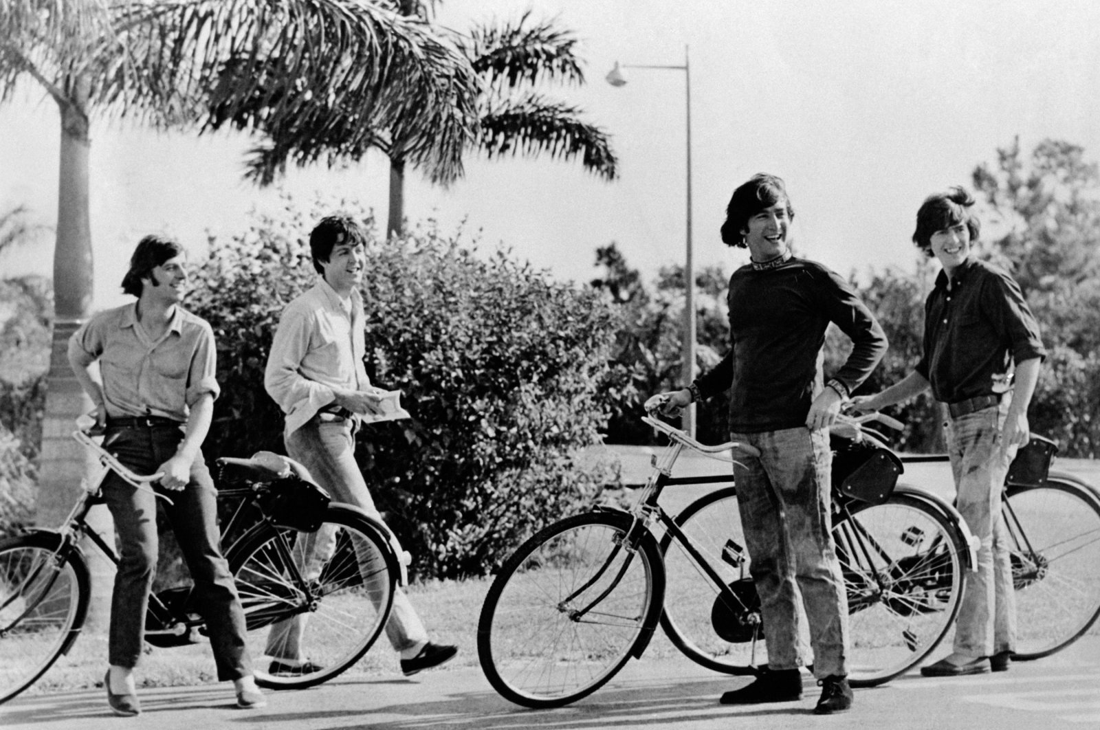 From left to right, The Beatles members including, Ringo Starr, Paul McCartney, John Lennon and George Harrison have fun riding bicycles in the 1960s. (Getty Images)