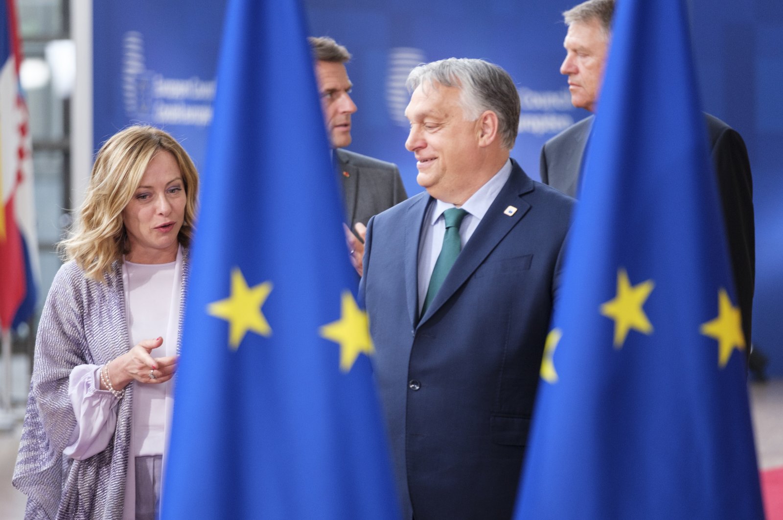 Italian Prime Minister Giorgia Meloni (L) speaks with Hungarian Prime Minister Viktor Orban (R). They are followed by French President Emmanuel Macron and Romanian President Klaus Werner Iohannis as they arrive for a group photo in the Europa building, Brussels, Belgium, June 27, 2024. (Getty Images Photo)