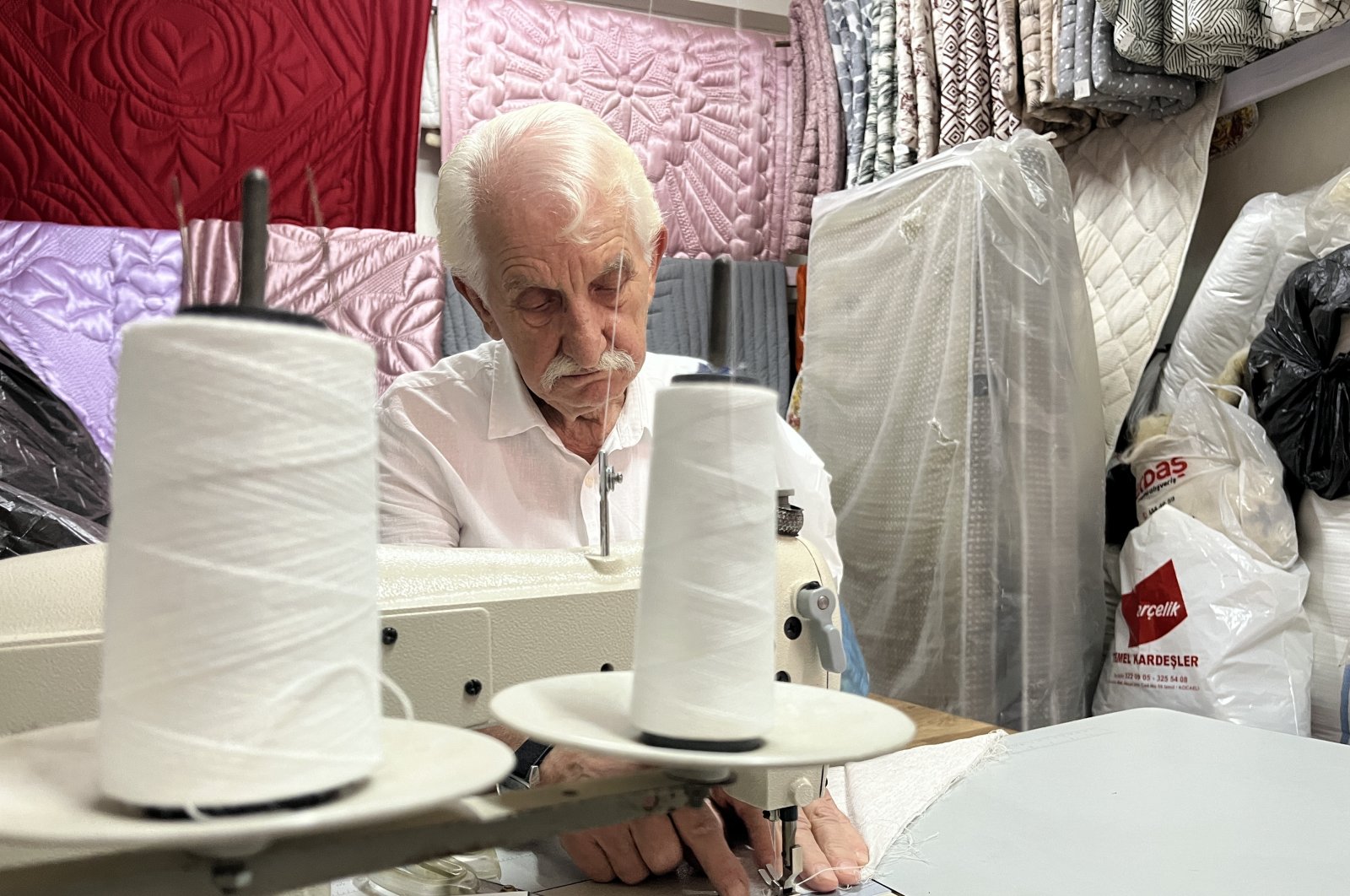 After decades, Ismail Çevikel continues to quilt in his shop, Izmit, Türkiye, Sept. 22, 2024. (IHA Photo) 