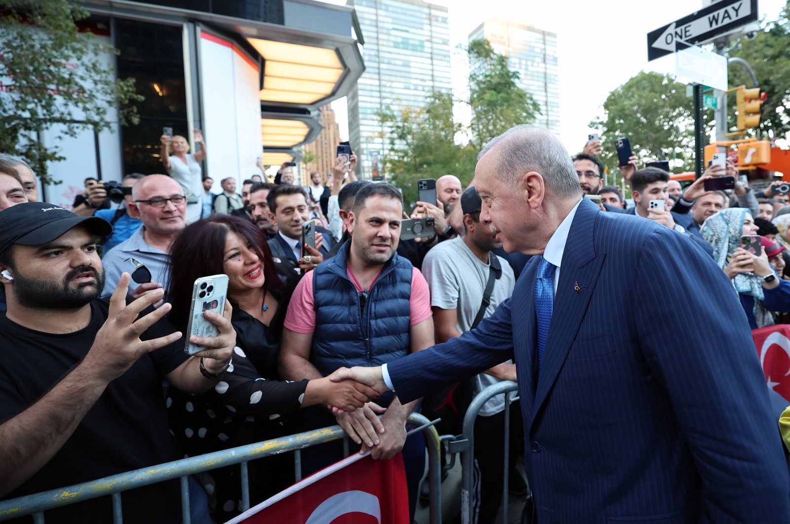 President Recep Tayyip Erdoğan shakes hands with people welcoming him and the first lady outside Turkish House (Türkevi), New York, U.S., Sept. 21, 2024. (AA Photo)