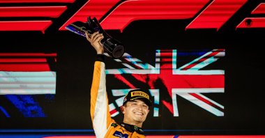 British driver Lando Norris of McLaren F1 Team celebrates on the podium after winning the Singapore Formula One Grand Prix at the Marina Bay Street Circuit, Singapore, Sept. 22, 2024. (EPA Photo)
