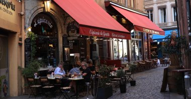 People sit at the terrasse of a traditional Bouchon Lyonnais restaurant in Lyon, southeastern France, Aug. 27, 2024. (AFP Photo)