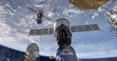 A handout still image taken from a handout video provided by the Russian Space Agency Roscosmos press-service shows the undocking of Soyuz MS-25 with participants of the 70th and 71st long-term expeditions, cosmonauts of the Roscosmos State Corporation Oleg Kononenko and Nikolai Chub, who spent a year on the International Space Station, as well as NASA astronaut Tracy Dyson, Sept. 23, 2024. (EPA/Roscosmos Handout)