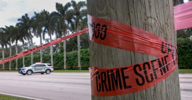 Crime scene tape marks off the area as law enforcement personnel continue to investigate the area where the Secret Service discovered a would-be assassin of former President Donald Trump at the Trump International Golf Club, Sept. 17, 2024. (Getty Images via AFP)