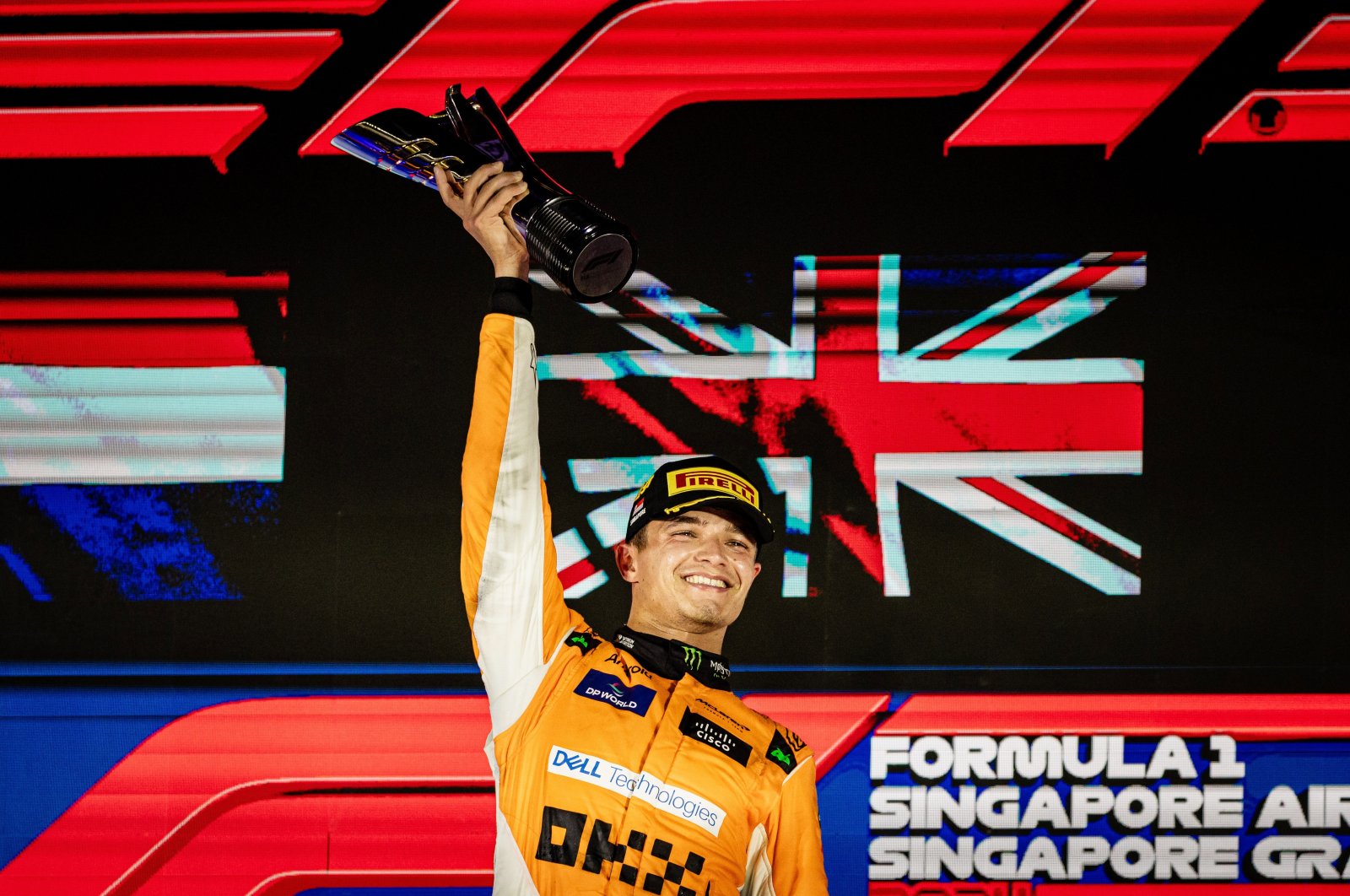 British driver Lando Norris of McLaren F1 Team celebrates on the podium after winning the Singapore Formula One Grand Prix at the Marina Bay Street Circuit, Singapore, Sept. 22, 2024. (EPA Photo)