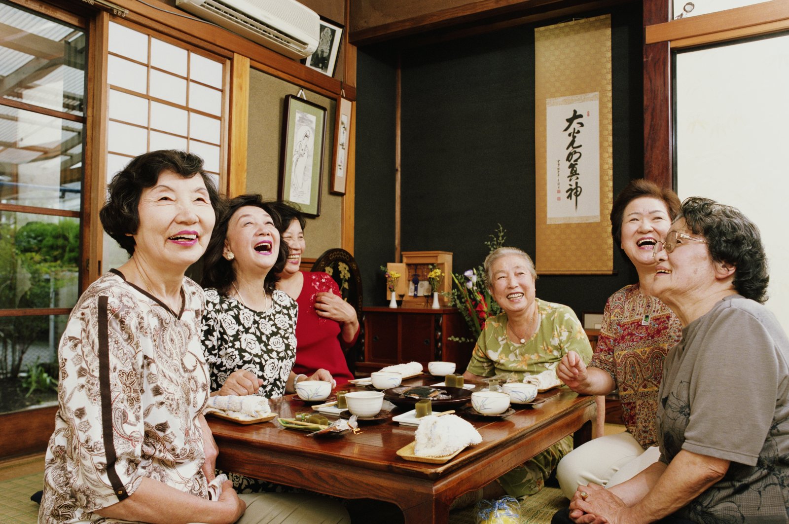 Six senior women having tea, laughing in Japan, Sept. 3, 2005. (Getty Images)