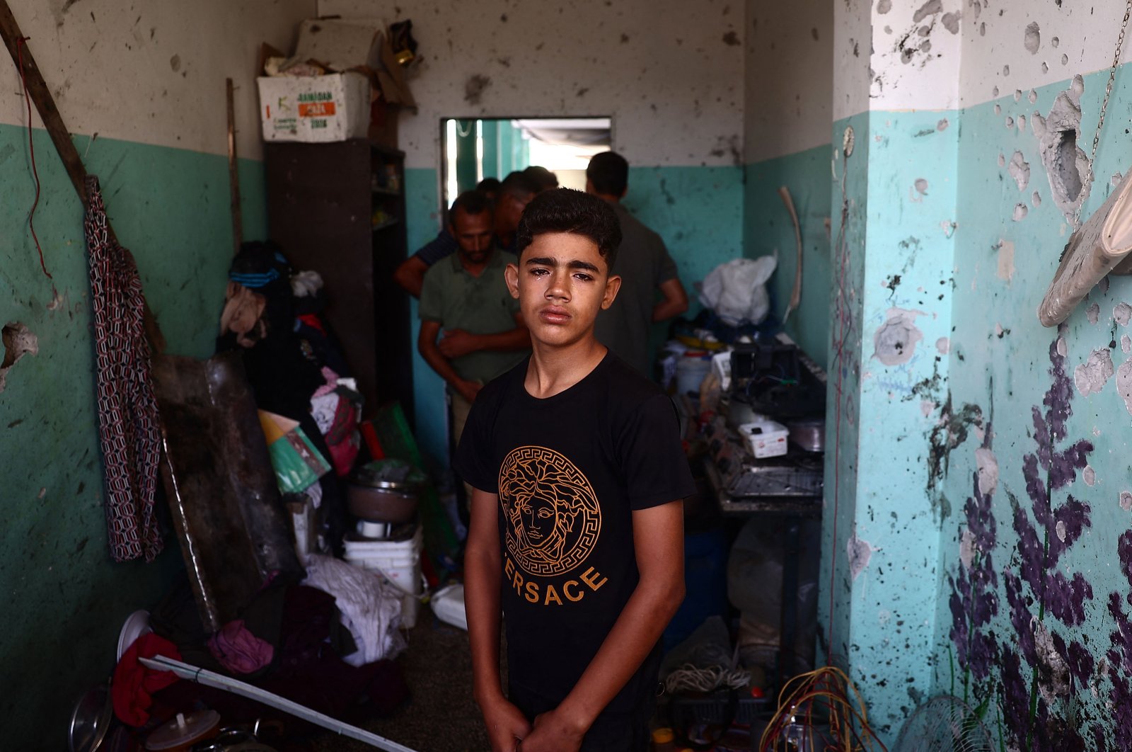 A Palestinian boy weeps as he checks the damage at a school room sheltering displaced people after an Israeli airstrike hit the site, in Nuseirat, central Gaza Strip, Sept. 23, 2024. (AFP Photo)