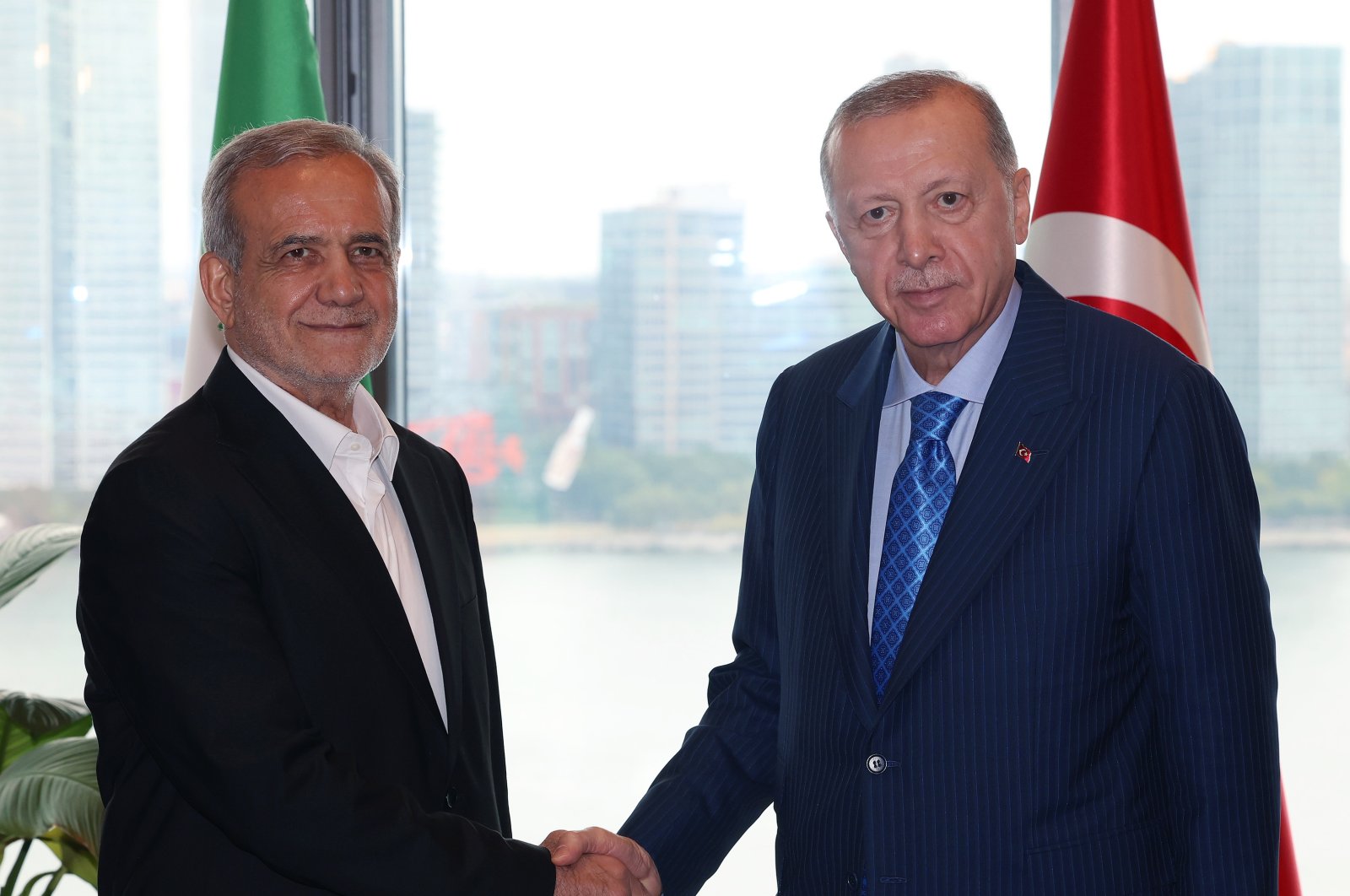 President Recep Tayyip Erdoğan and Iranian President Masoud Pezeshkian shake hands at the Turkish House in New York, Sept. 23, 2024. (DHA Photo)