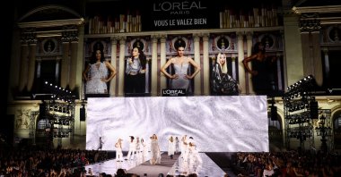 A model presents a creation during a public show named "Walk Your Worth" organized by L&#039;Oreal near the Opera Garnier as part of Paris Fashion Week, Paris, France, Sept. 23, 2024. (Reuters Photo)