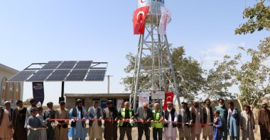 Participants cut the ribbon to inaugurate the TIKA-built galvanized water tank, Balkh, Afghanistan, Sept. 24, 2024. (AA Photo)