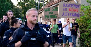 Police officers accompany demonstrators with placards reading "Racism is no alternative" close to the election party venue of the far-right Alternative for Germany (AfD) party, Potsdam, Germany, Sept. 22, 2024. (AFP Photo)