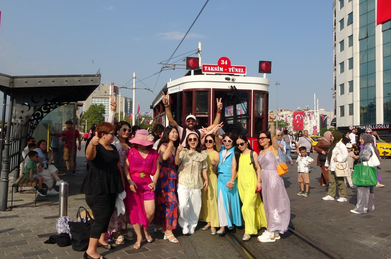 Chinese tourists pose for a photo in the famed Istiklal Street in Istanbul, Türkiye, Aug. 31, 2024. (IHA Photo)