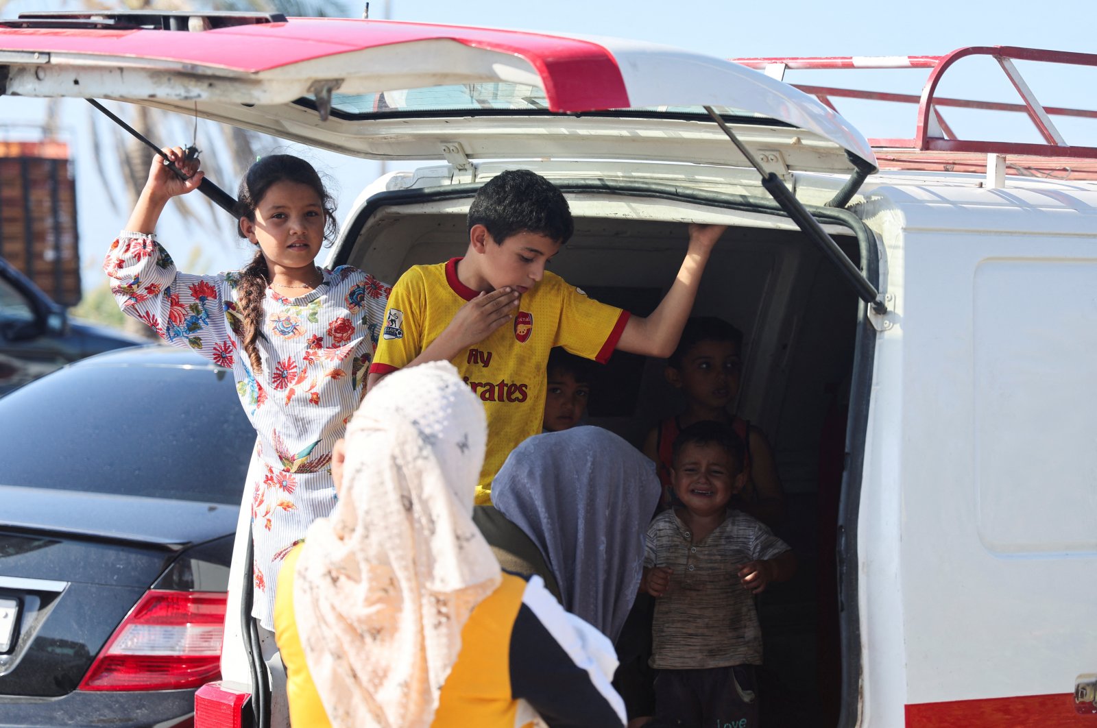 Children stand in a van while people in heavy traffic drive north southern coastal city Sidon, Lebanon, Sept. 23, 2024. (Reuters Photo)