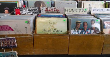 An old record by Turkish folk music legend Neşet Ertaş (C) is for sale at a shop in an open market, Ankara, Türkiye, Oct. 3, 2021. (Shutterstock Photo)