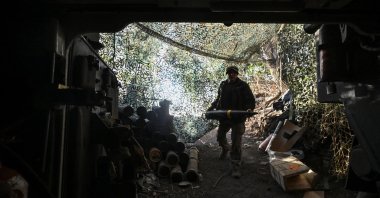 A Ukrainian serviceman carries a 155 mm shell before firing toward Russian troops at a front line, amid Russia’s attack on Ukraine, Kharkiv region, Ukraine, Sept. 24, 2024. (Reuters Photo)