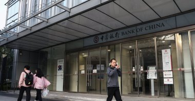 People walk beside a Bank of China in Beijing, China, Sept. 24, 2024. (EPA Photo)