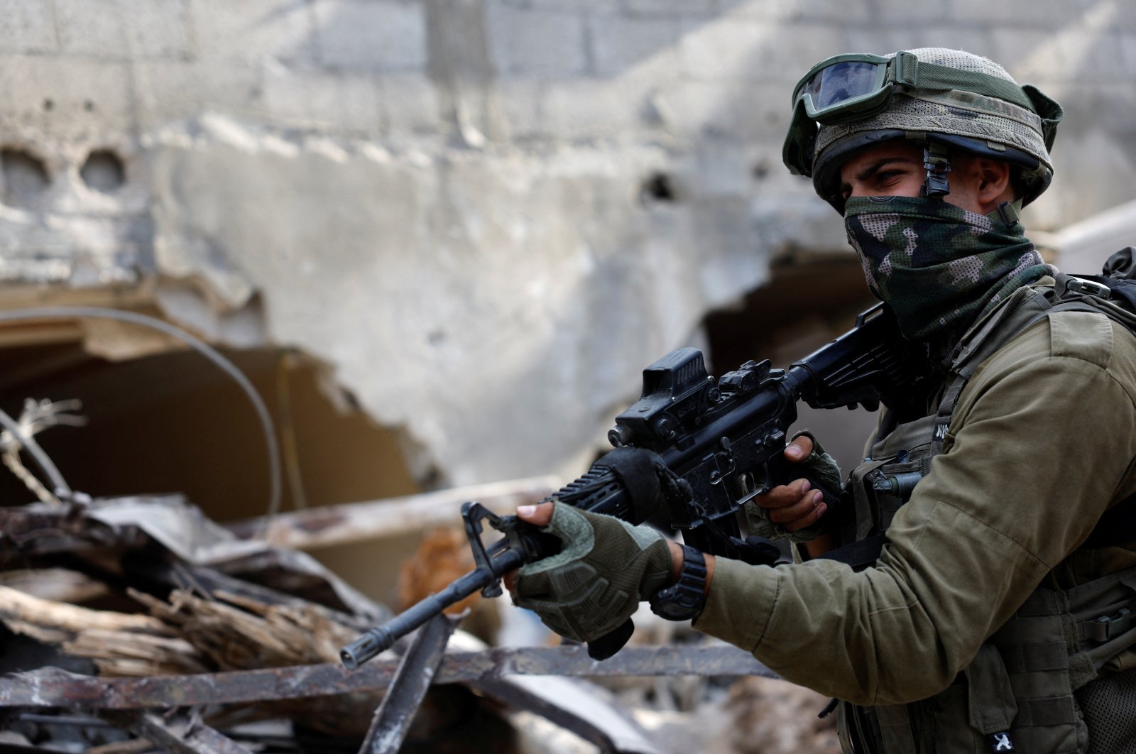 An Israeli Soldier holds a weapon, amid the ongoing ground operation of the Israeli army against Palestinian Islamist group Hamas, in the Gaza Strip, Lebanon, Sept. 13, 2024. (Reuters Photo)