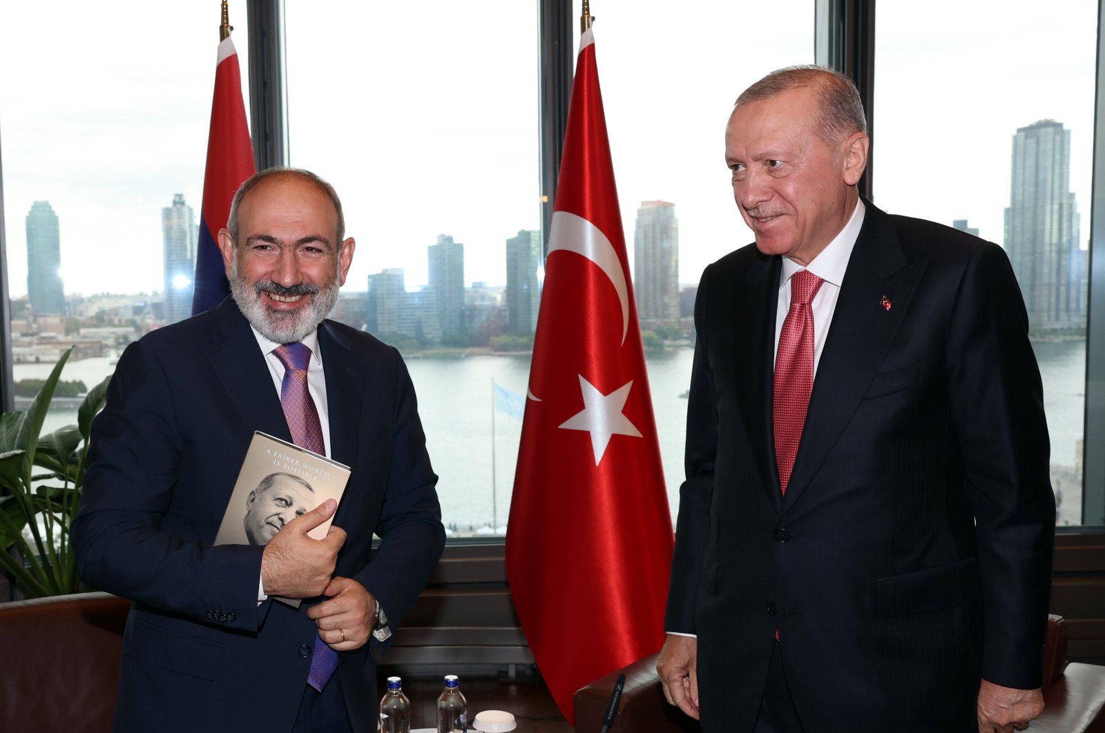 President Recep Tayyip Erdoğan and Armenian Prime Minister Nikol Pashinyan (L) pose as Pashinyan holds a book Erdoğan gifted to him in New York, U.S., Sept. 24, 2024. (AA Photo)