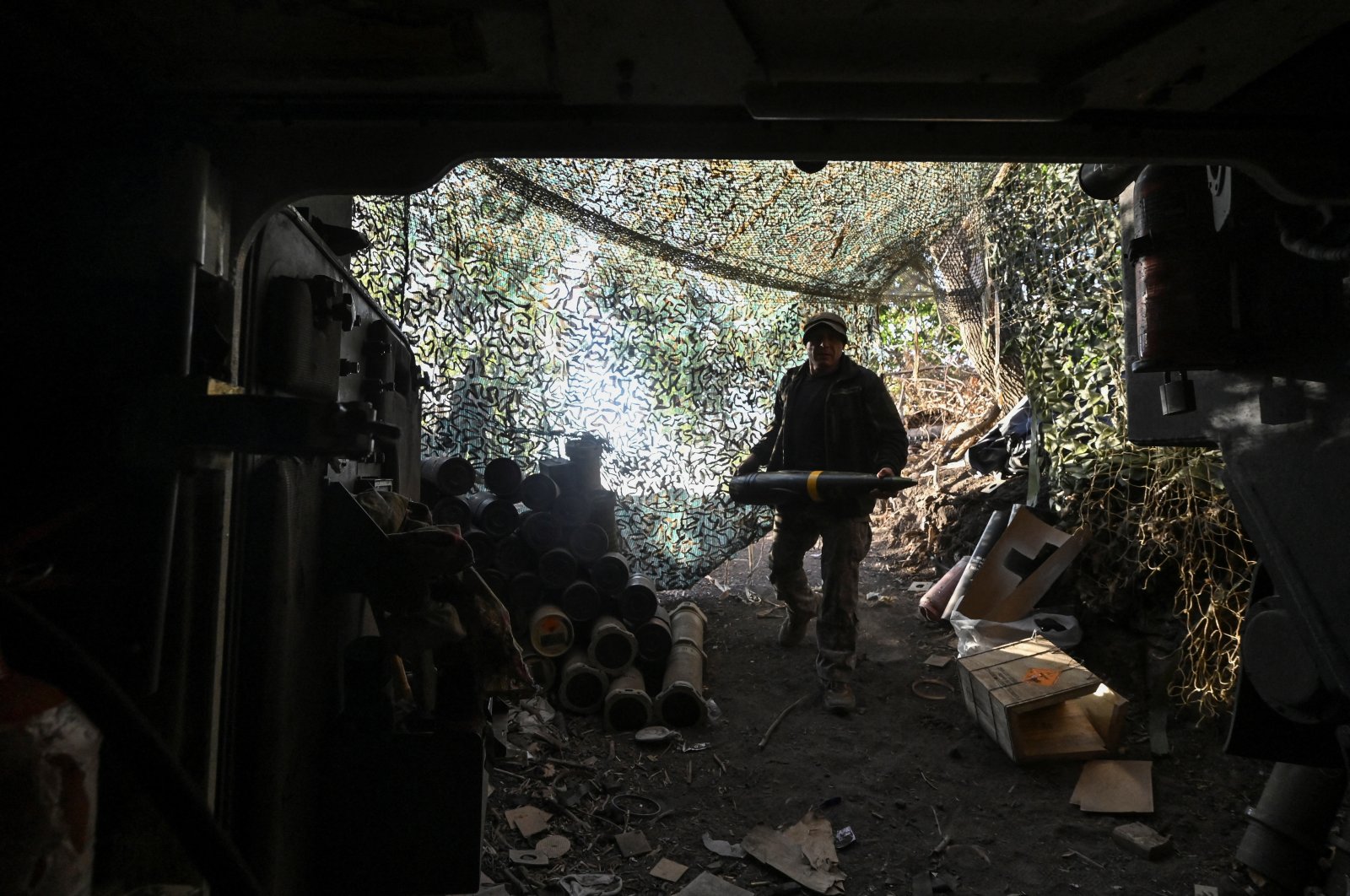 A Ukrainian serviceman carries a 155 mm shell before firing toward Russian troops at a front line, amid Russia’s attack on Ukraine, Kharkiv region, Ukraine, Sept. 24, 2024. (Reuters Photo)