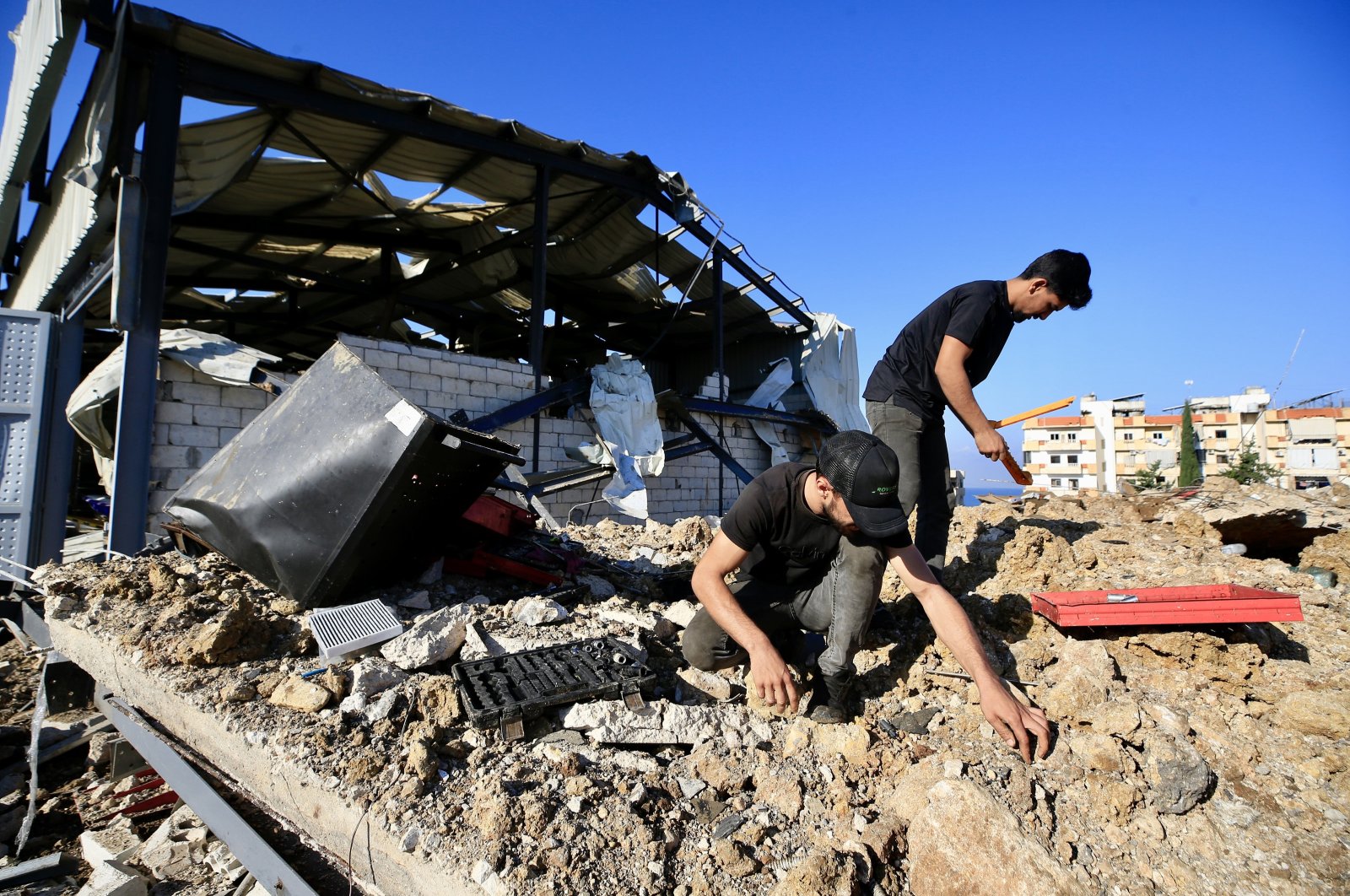 People inspect the area near a damaged building after Israeli raids in Jiyeh, South Lebanon, Sept. 25, 2024. (EPA Photo)