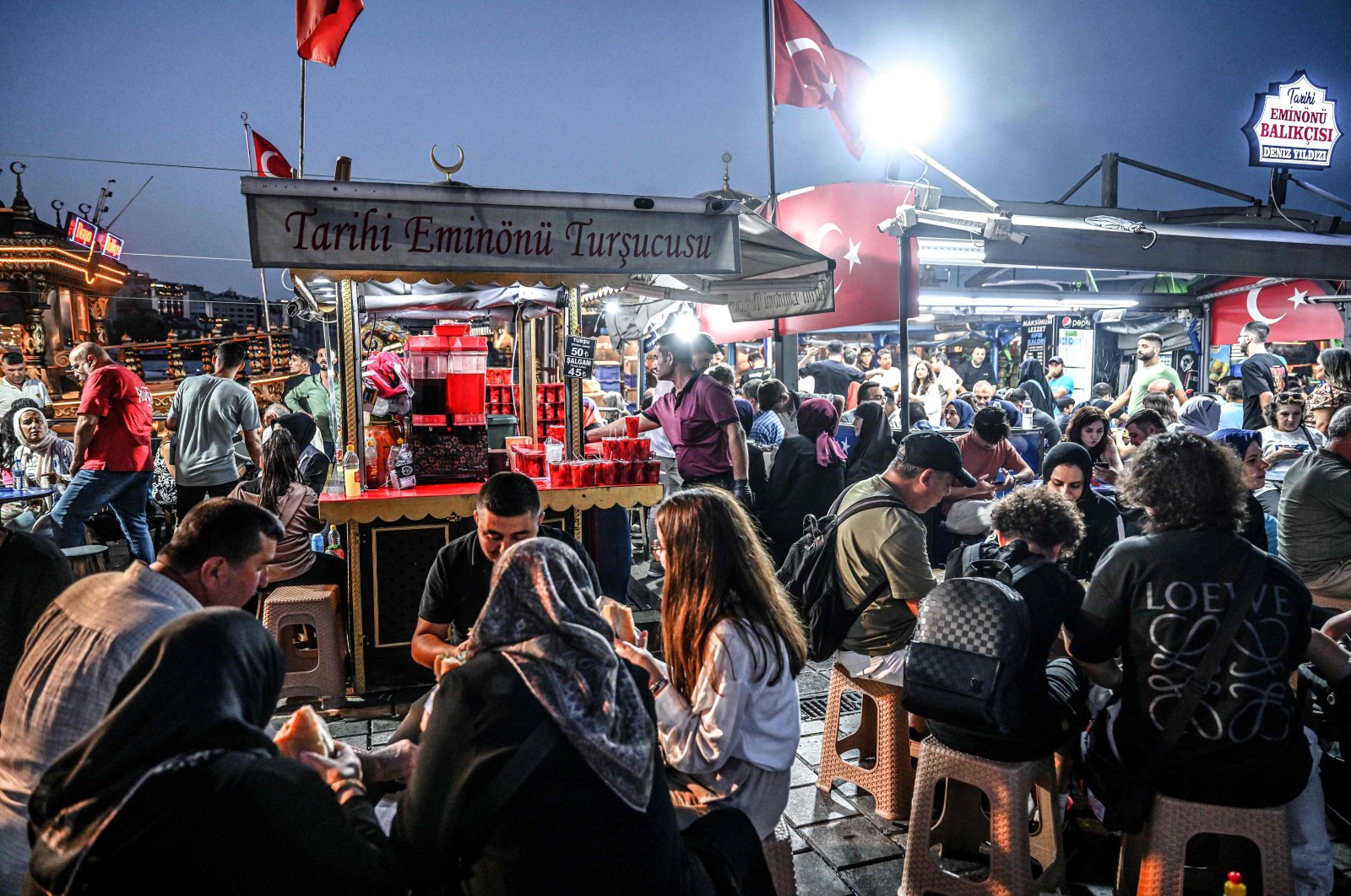 A street vendor sells pickles and pickle juice in the famed Eminönü neighborhood of Istanbul, Türkiye, Aug. 30, 2024. (AFP Photo)