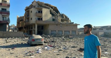 A man walks past destruction caused by Israeli airstrikes in the Masaken neighborhood, Tyre, Lebanon, Sept. 26, 2024. (AFP Photo)