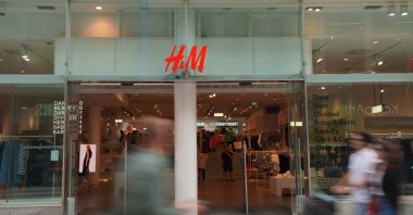 Pedestrians and shoppers walk past a branch of fashion retailer H&amp;M in Stockholm, Sweden, July 17, 2023. (Reuters Photo)