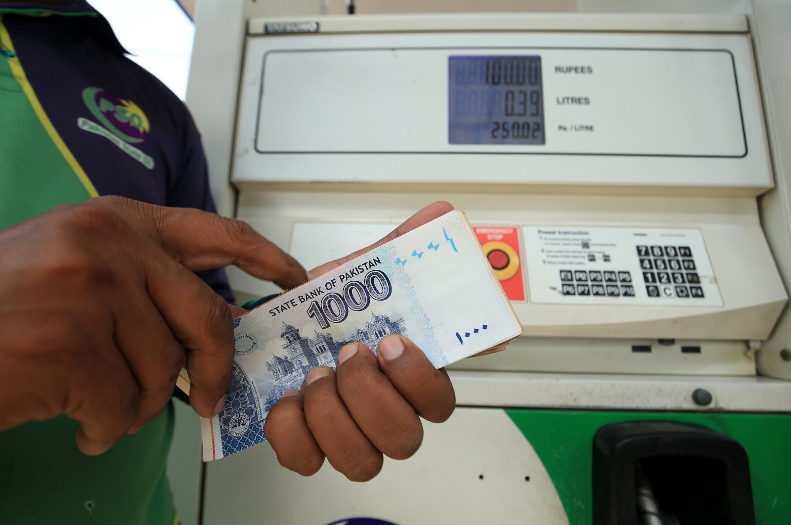 A gas station worker counts Pakistani rupees at a gas station in Peshawar, Pakistan, Sept. 16, 2024. (EPA Photo)