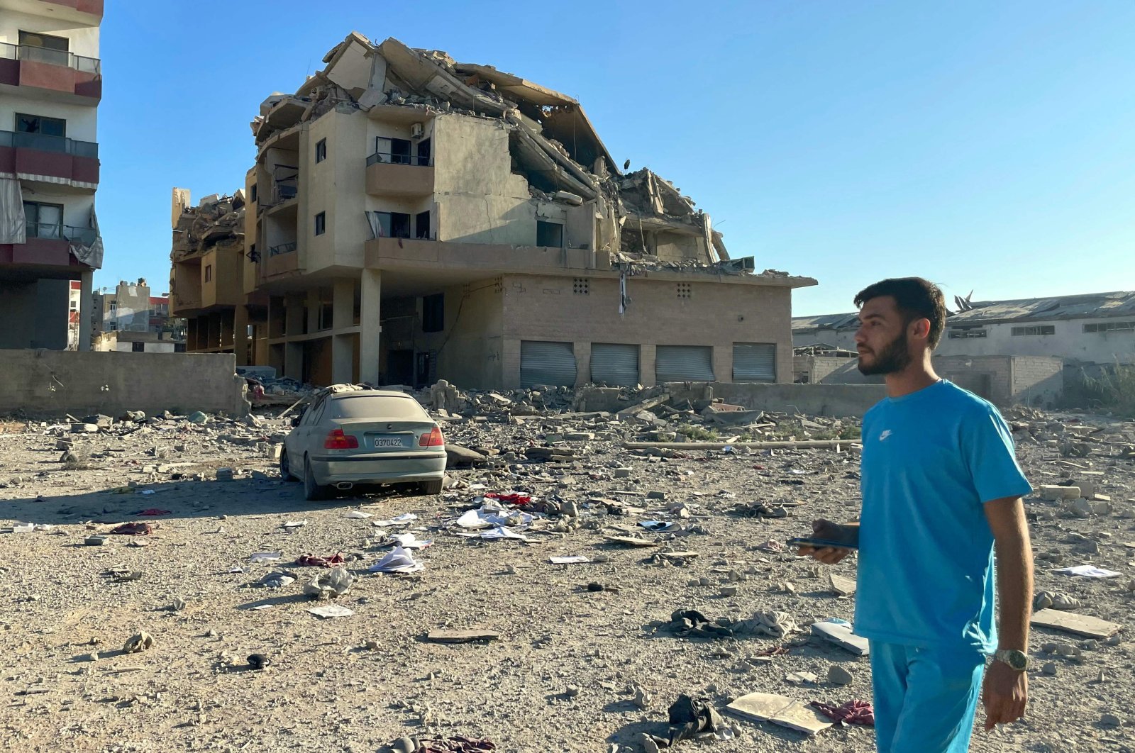 A man walks past destruction caused by Israeli airstrikes in the Masaken neighborhood, Tyre, Lebanon, Sept. 26, 2024. (AFP Photo)