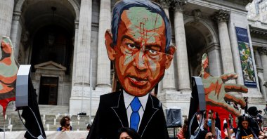 A woman stands near a representation of Israeli Prime Minister Benjamin Netanyahu as pro-Palestinian protesters rally against Israel's strikes on Gaza and Lebanon in New York City, U.S., Sept. 26, 2024. (Reuters Photo)