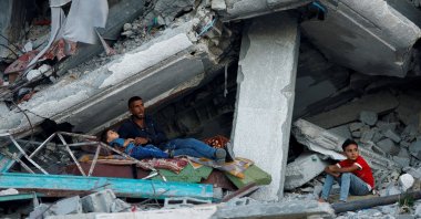 A Palestinian family rests under the rubble of a house destroyed in Israeli strikes, Khan Younis in the southern Gaza Strip, Palestine, Sept. 26, 2024. (Reuters Photo)