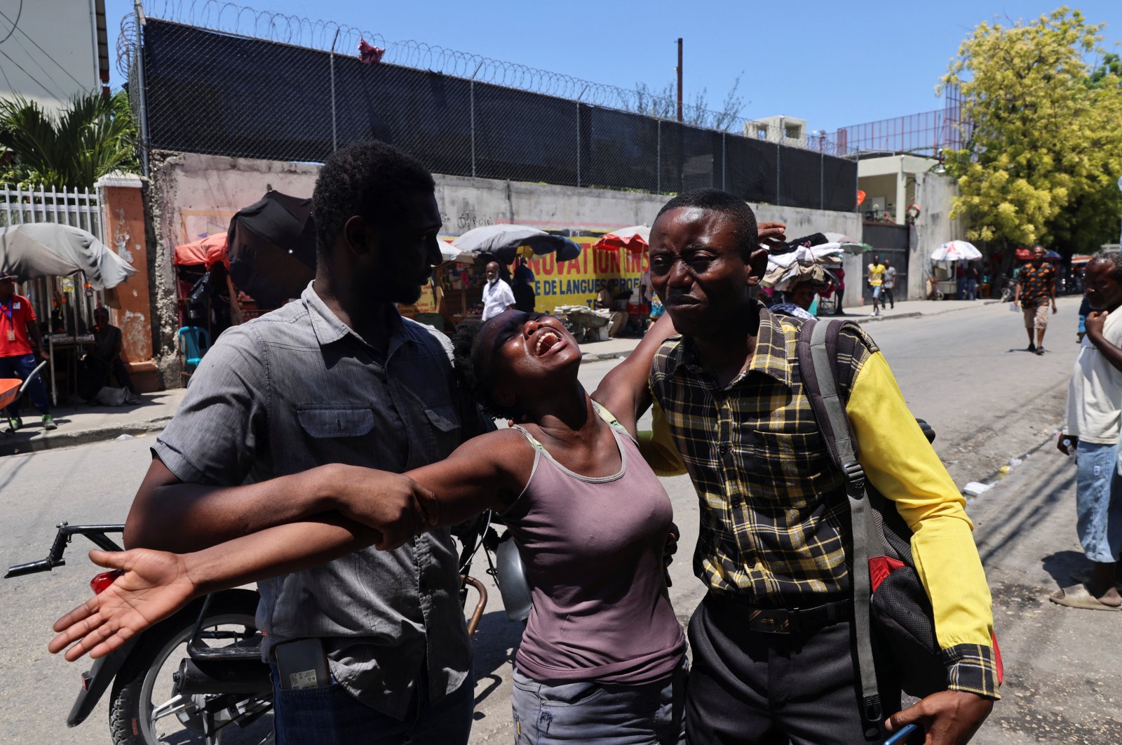 A woman is helped by others as she reacts upon seeing the dead body of her brother who was shot dead by unknown assailants, Port-au-Prince, Haiti, Sept. 9, 2024. (Reuters Photo)