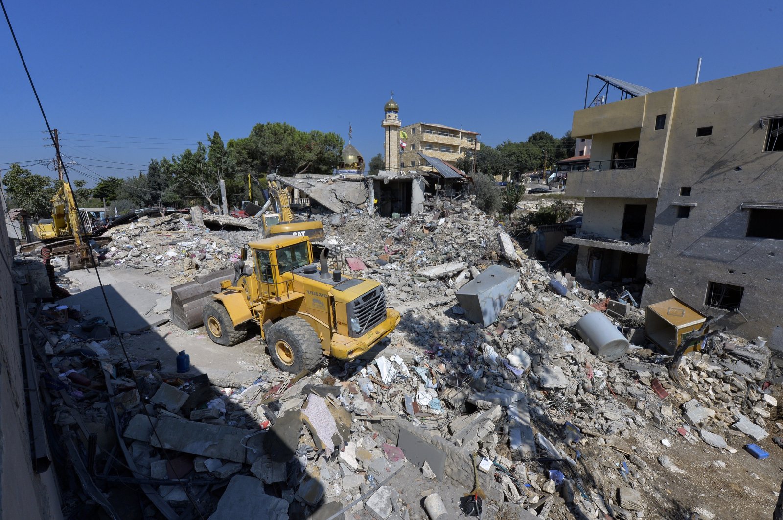 Excavators clear the rubble at the site of an Israeli strike in the village of Maaysra, Sept. 27, 2024. (EPA Photo)