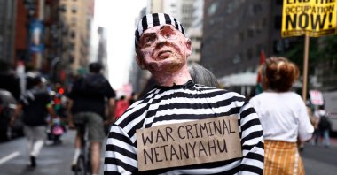 A person holds an effigy of a man reading &quot;war criminal Netanyahu&quot; as pro-Palestinian protesters march through the streets of New York as a part of a city-wide protest against Israeli Prime Minister Benjamin Netanyahu, New York, U.S., Sept. 26, 2024. (AFP Photo)