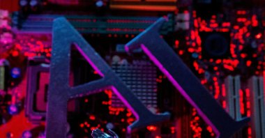 The letters "AI" and a robot hand are placed on a computer motherboard in this illustration taken on June 23, 2023. (Reuters Photo)