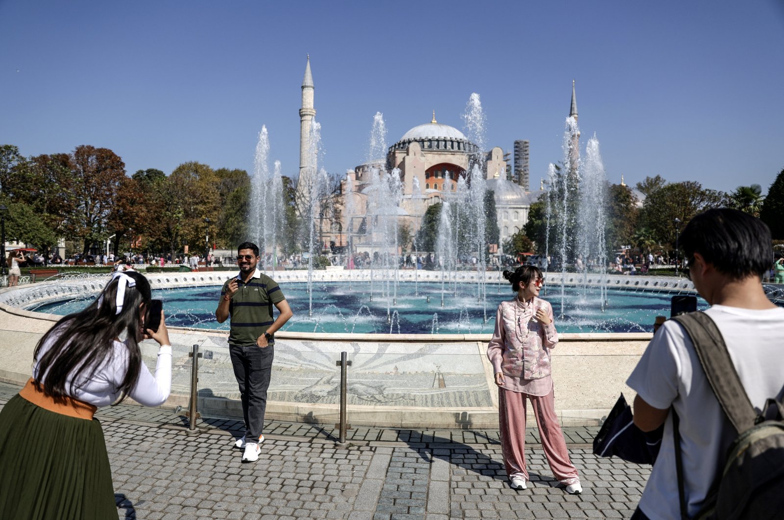 Tourists pose and take pictures in front of a water fountain near the Hagia Sophia Grand Mosque on World Tourism Day, Istanbul, Türkiye, Sept. 27, 2024. (EPA Photo)