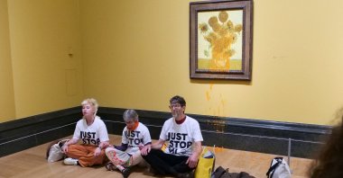A handout picture from the Just Stop Oil climate campaign group shows three activists sitting on the floor under Vincent Van Gogh&#039;s "Sunflowers" in central London, U.K., Sept. 27, 2024. (AFP Photo)