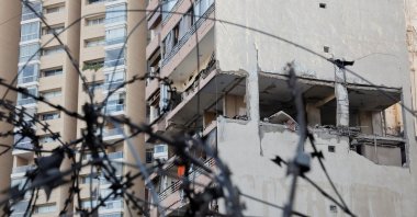 A building damaged in an Israeli strike is seen through a razor wire fence, in Kola, central Beirut, Lebanon, Sept. 30, 2024. (Reuters Photo)