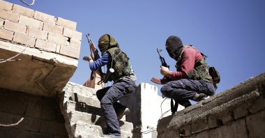Two PKK terrorists run as they attack Turkish security forces in the Nusaydin district, bordering Syria, in southeastern Mardin province, Türkiye, March 1, 2016. (AP Photo)