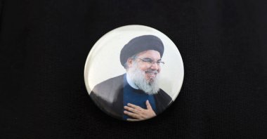 An Iraqi wears a pin showing Lebanon's Hezbollah chief Hasan Nasrallah, in Baghdad, Iraq, Sept. 22, 2024. (AFP Photo)