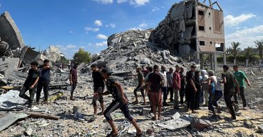 Palestinians gather at the site of an Israeli strike on a residential building amid the Palestinian-Israeli conflict in Nuseirat in the central Gaza Strip, Sept. 30, 2024. (Reuters Photo)