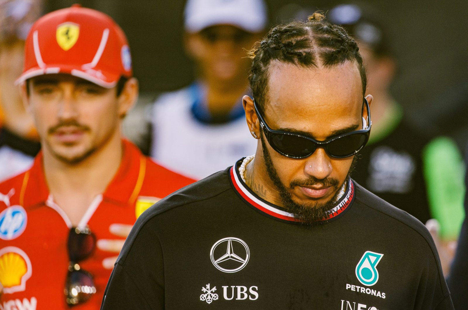 British driver Lewis Hamilton of Mercedes-AMG Petronas (R) and Monaco&#039;s driver Charles Leclerc of Scuderia Ferrari arrive for the drivers&#039; parade ahead of the Singapore Formula One Grand Prix, Singapore, Sept. 22, 2024. (EPA Photo)