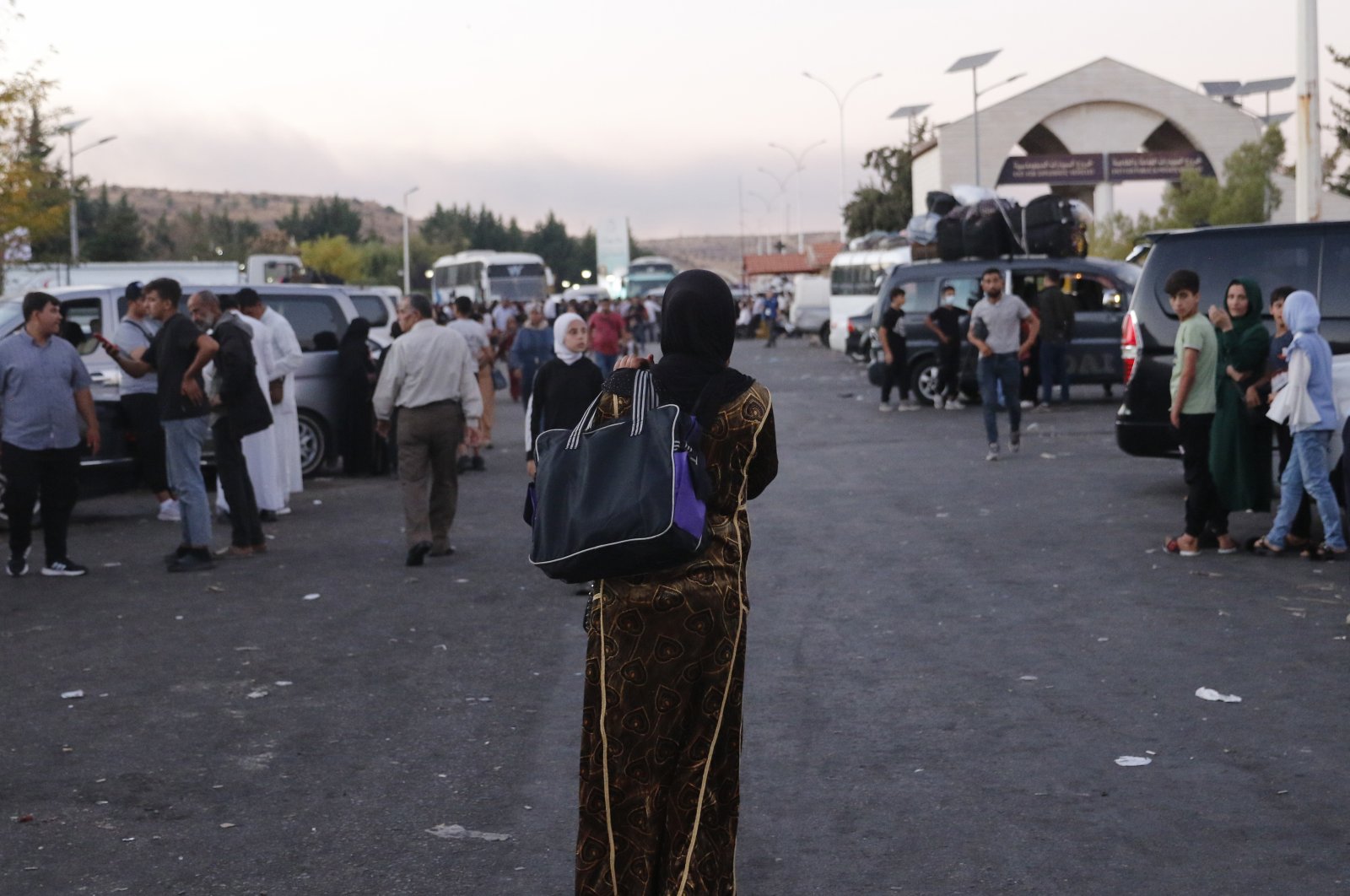 A woman walks as people who fled from southern Lebanon arrive at the Masnaa Border Crossing with Lebanon, Jdeidat Yabous, Syria, Sept. 25, 2024. (EPA Photo)