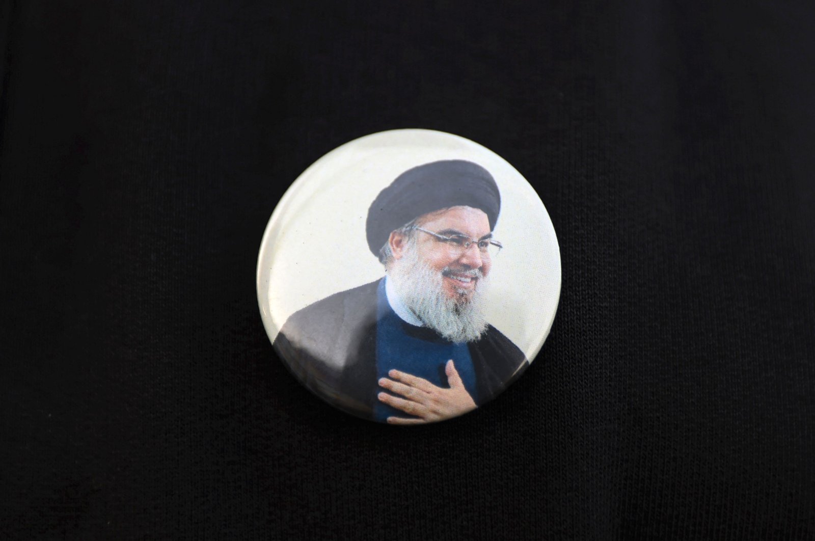 An Iraqi wears a pin showing Lebanon&#039;s Hezbollah chief Hasan Nasrallah, in Baghdad, Iraq, Sept. 22, 2024. (AFP Photo)