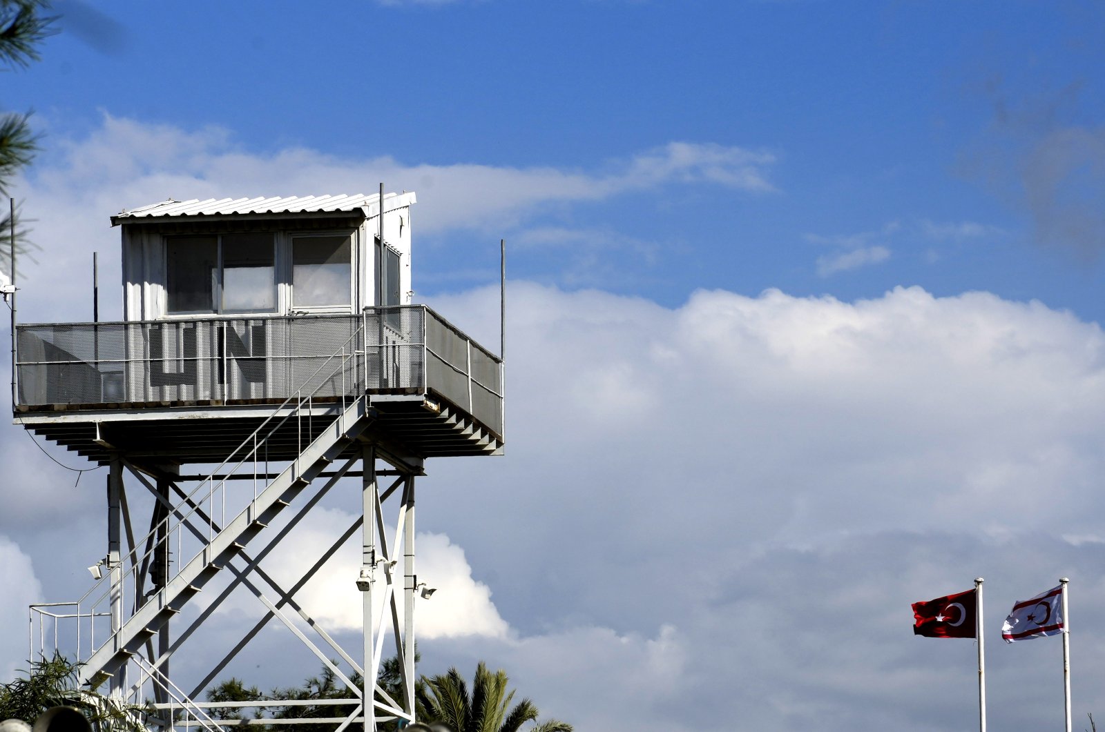 A U.N guard post at the U.N controlled area is seen near a Turkish and TRNC flag at the north part of the divided capital Lefkoşa, Wednesday, March 15, 2023. (AP File Photo)