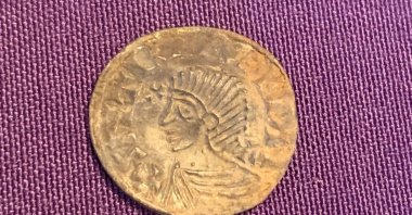 A view of a coin depicting King Sihtric Silkbeard from a rare hoard of 1,000-year-old silver coins unearthed during metal-detecting in Douglas, Isle of Man, in this handout released on Oct. 1, 2024. (Reuters Photo)