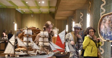 Visitors attend an exhibition of model ships made by the Madagascar company Le Village and on display at the Homo Faber 2024 show, Venice, Italy, Sept. 13, 2024. (AP Photo)