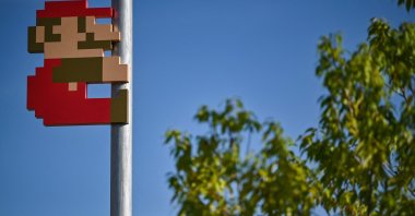 This photo shows a Super Mario on a pole in the courtyard during a media preview of the new Nintendo Museum in the suburbs of Kyoto, Japan, Sept. 24, 2024. (AFP Photo)